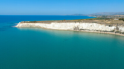 Aerial view of Eraclea Minoa coastline, located in province of Agrigento, Sicily, Italy. It's characterized by a high white cliff. It's a beautiful sunny day. The Mediterranean sea in foreground.