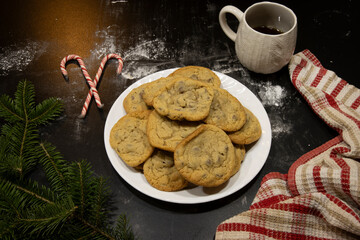 Plate of Homemade Chocolate Chip Cookies with Coffee and Festive Holiday Accents