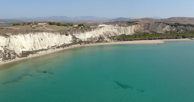 Aerial view of Eraclea Minoa beach, located in province of Agrigento, Sicily, Italy. It's characterized by a high white cliff. It's a beautiful sunny day. The Mediterranean sea in foreground.