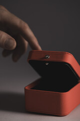 Hand reaching red jewelry gift box