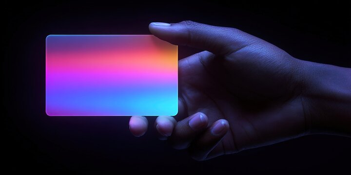 Hand holding a colorful credit card against a dark background showing vibrant gradients of blue, pink, and purple