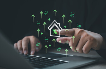 Businessman touching digital house icon with rising interest rate symbols. Concept of real estate investment, financial growth, mortgage, and economy trends in modern property market.