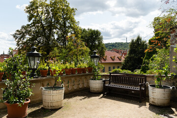Obraz premium Prague, Czech Republic – August 6, 2025: Garden terrace overlooking red rooftops towards Petrin Lookout Tower in the Palace Gardens Below Prague Castle, Malá Strana, Prague, Czech Republic