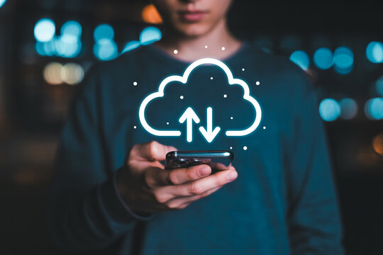 Person using a smartphone with a cloud computing icon overlay showcasing data transfer and storage solutions for mobile devices in a modern digital environment with a blurred background - Powered by Adobe