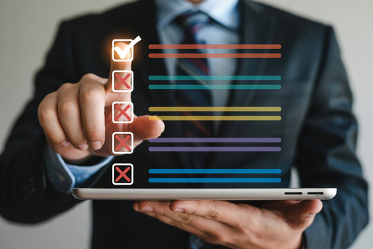Businessman using a digital tablet to complete a checklist highlighting task management productivity and digital workflow in a modern business environment for efficiency and organization - Powered by Adobe