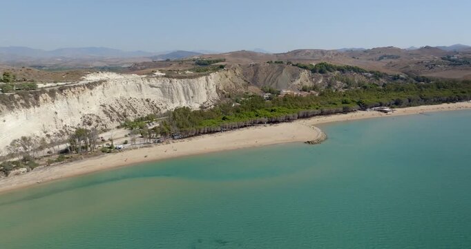 Aerial view of Eraclea Minoa beach, located in province of Agrigento, Sicily, Italy. It's characterized by a high white cliff. It's a beautiful sunny day. The Mediterranean sea in foreground.