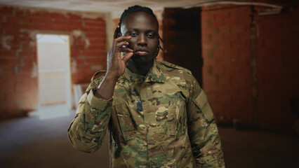 Man soldier in camouflage uniform touching his face and pinching nose with hand, dogtag visible,...
