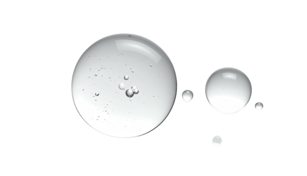 Close-up of transparent liquid droplets against a stark black background