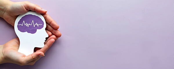 Hands hold brain cutout. Paper head with encephalography on purple background. Alzheimer, autism awareness, stroke, epilepsy, ADHD, seizure disorder, mental health challenges concept. Support,