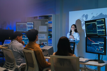 young Asian software development manager leads a late-night office discussion with his executive team, mentoring developers and analyzing source code to guide programming and project development	