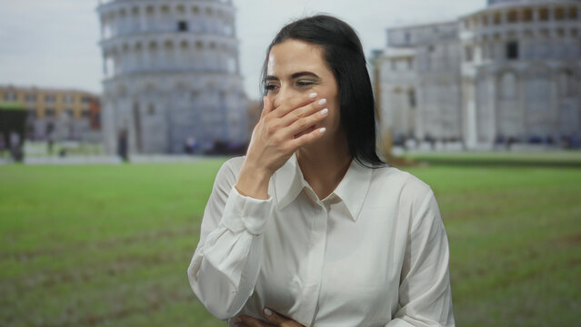 Fototapeta Woman smiling outdoors in front of the iconic leaning tower of pisa in a sunny street scene, embracing the vibrant energy of this famous italian landmark.