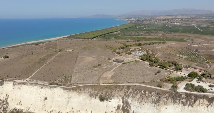 Aerial view of the archaeological site of Eraclea Minoa, located in the province of Agrigento, Sicily, Italy. It is located on a hill overlooking the azure waters of the Mediterranean Sea.