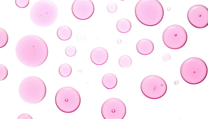 Overhead shot of pink, circular liquid droplets against a stark, black background