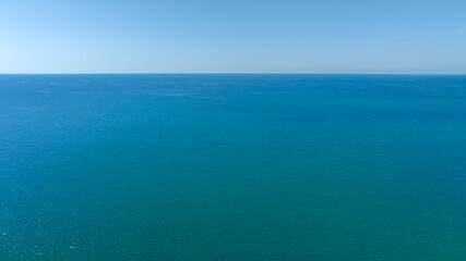 Obraz premium Aerial view of the azure and turquoise sea stretching to the horizon.