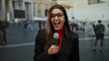 Woman reporter smiling confidently with microphone in vatican st peter's square under clear sky...