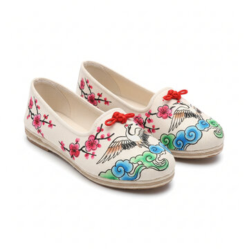 Elegant embroidered traditional Chinese style shoes featuring cranes and floral designs, offering comfortable cultural artistry for modern fashion statements and unique expression