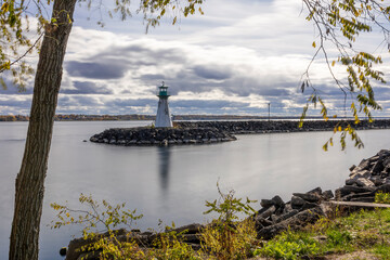 Serene view of Prescott Marina and lighthouse on the St. Lawrence River, capturing the tranquil ambiance of Ontario's riverside beauty.