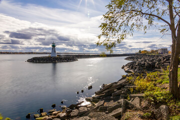 Serene view of Prescott Marina and lighthouse on the St. Lawrence River, capturing the tranquil ambiance of Ontario's riverside beauty.