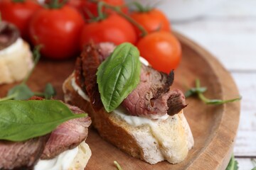 Bruschettas with roast beef served on table, closeup