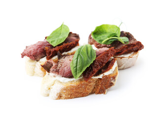Bruschettas with roast beef, cream cheese, basil and sun-dried tomato isolated on white