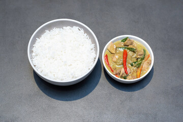 Experience the rich, aromatic flavors of authentic Thai green curry with succulent chicken and fiery chilies, perfectly paired with fluffy steamed rice for a truly satisfying meal.