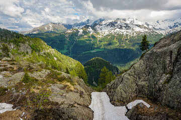A Alps mountain range with snow on the peaks and a rocky cliff