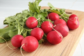 Fresh ripe radishes on white table, closeup