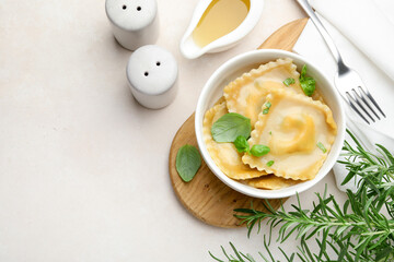 Delicious ravioli with basil served on light table, flat lay. Space for text
