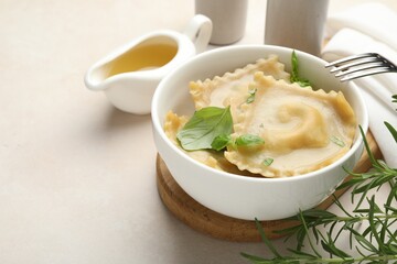 Delicious ravioli with basil served on light table, closeup. Space for text