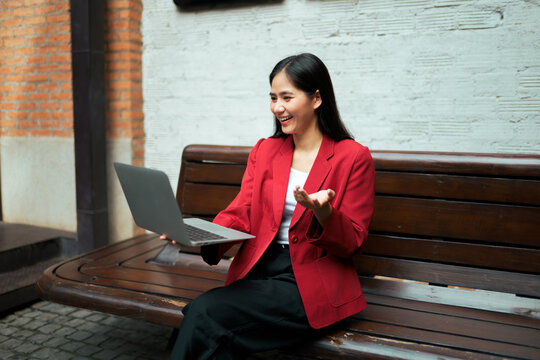 Businesswoman having video call on laptop working remotely