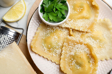 Delicious ravioli with cheese served on white marble table, flat lay
