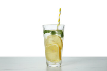 Refreshing water with lemon and mint in glass on marble table against white background