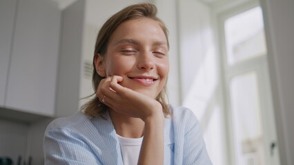 Fototapeta premium Happy woman resting kitchen in sunlight closeup. Smiling housewife look camera