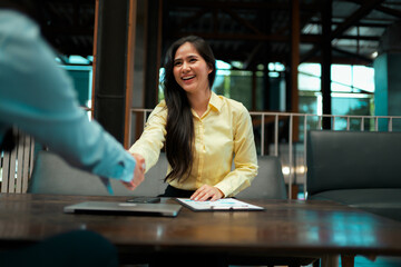 Businesswoman shaking hands completing a successful deal