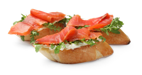 Tasty bruschettas with salmon and arugula isolated on white