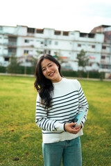 Asian student woman smiling holding book at campus