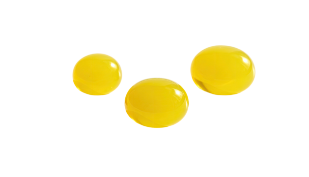 Three round, bright yellow objects against a stark black background, appearing glossy