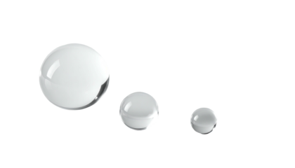 Three shiny, white, spherical objects of varying sizes arranged on a stark black background