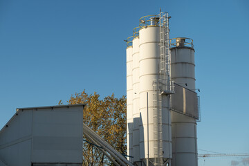 Industrial silos and factory structure against blue sky
