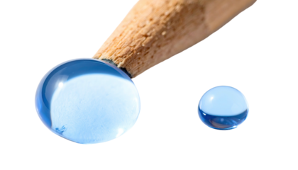 Close-up view of clear, shiny water drops on a wooden object, set against a black backdrop