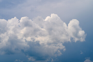 A Serene Cloudy Sky Embraced by Soft, Fluffy White Clouds Glowing Under the Sunlight