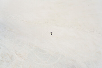 A mountaineer with a backpack and a red helmet is walking across the snow cover in the high mountains of the French Alps Climbing Mont Blanc