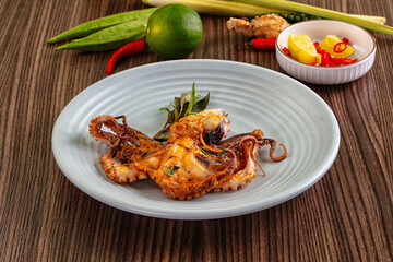 Gourmet grilled whole octopus served lime