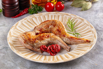 Roasted rabbit leg served rosemary