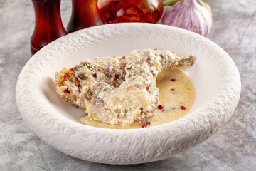 Roasted rabbit legs in cream sauce