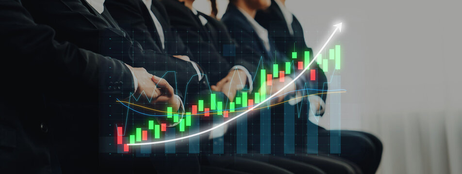 Business professionals in suits study stock market trends with visual graphs, showcasing growth opportunities and financial performance during a corporate meeting. Axiom