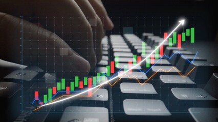 Engaging scene showing hands typing on a keyboard with overlay of finance chart, illustrating stock...