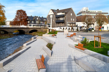 Waterfront promenade with benches at the market square in downtown Berlebug, Germany