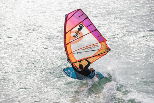 Windsurfer performing radical jump over ocean waves