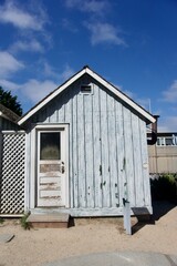 Obraz premium Rustic Coastal Cottage with Teal Window, Monterey California